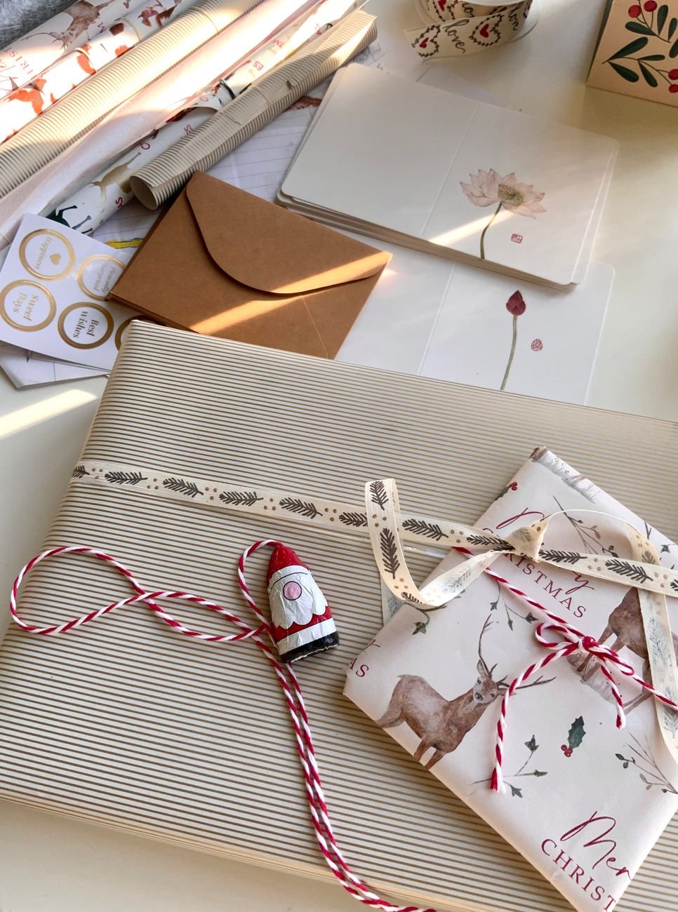 Beautifully wrapped stationery gift with warm paper and ribbon
